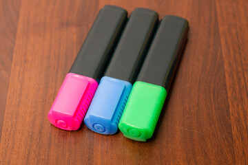 Felt tip pens on a wooden background. Office and school supplies. Color marker