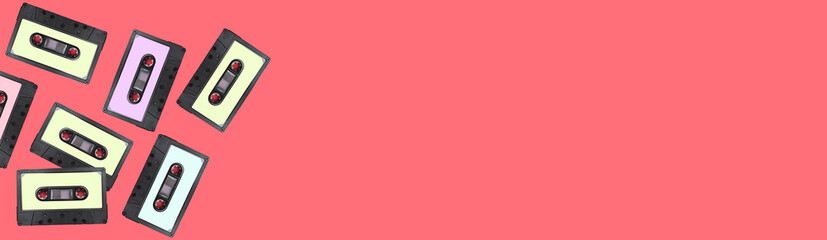 Retro collection of cassettes on a pink background, top view. copy space.