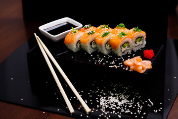 Sushi with salmon. Soy sauce, ginger, red caviar. Roles with red fish.