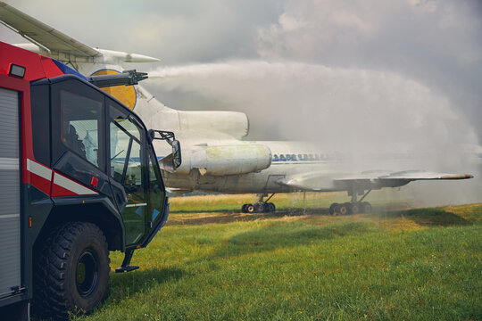 Picture part of aircraft and red modern machine in the field