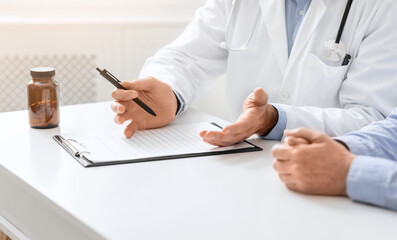 Doctor explaining medical prescription for senior patient
