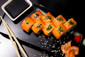 Sushi with salmon. Soy sauce, ginger, red caviar. Roles with red fish.