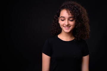 Fototapeta premium Portrait of young beautiful Persian teenage girl with curly hair