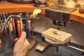 Skilled worker preparing a fuel-burning tool for metalworking