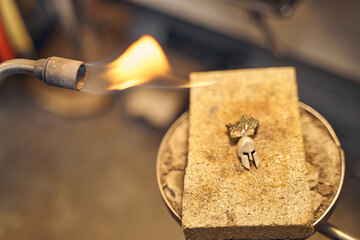 Glowing gas-fueled handheld blowlamp used for metalworking