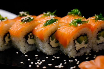 Sushi with salmon. Soy sauce, ginger, red caviar. Roles with red fish.