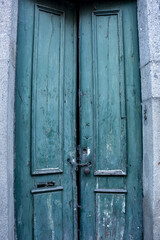 Fototapeta na wymiar Weathered And Derelict Green Doors, Chainlocked, Braga, Portugal