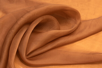 Brown fabric background silk, satin or organza.