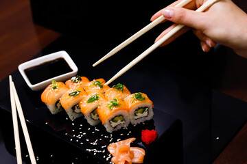 Sushi with salmon. Soy sauce, ginger, red caviar. Roles with red fish.