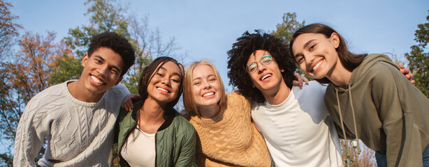 Portrait of overjoyed teenagers having fun outdoors