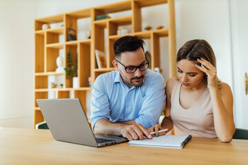 Portrait of a couple managing home finances.