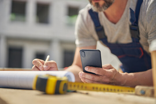 Qualified constructor engineer drawing a floor plan