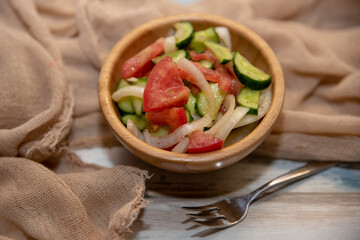 cucumber and tomato salad in a wooden bowl