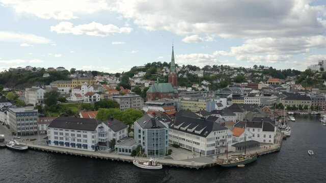 Clarion Hotel In Tyholmen And The Trinity Church On The Background In Arendal, Norway.  - aerial drone (backward)