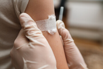 Adhesive bandage on arm after injection vaccine.