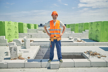 Male worker standing at a building site