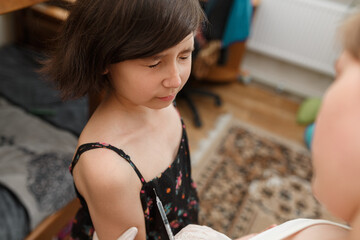 Child afraid of vaccine injection in the arm.