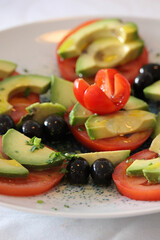 Tomato and avocado salad with olives
