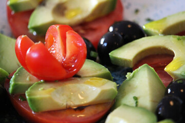 Tomato and avocado salad with olives