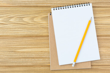 Open spiral album and pencil with an eraser.