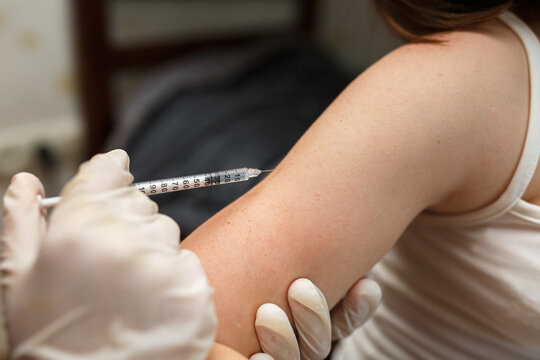 Nurse vaccinating  in arm. Health and care concept