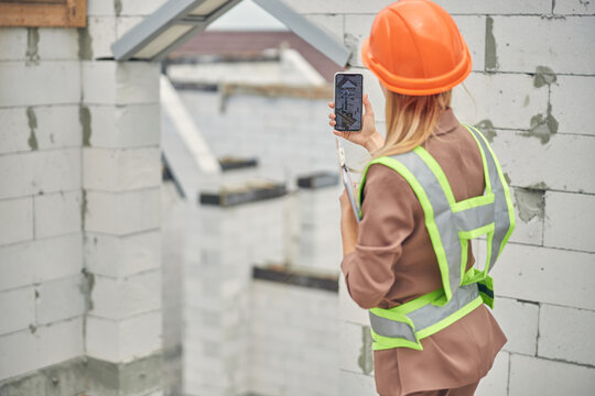 Civil engineer using her cellphone at work