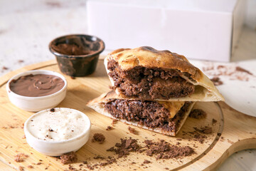 Hot brownie filled in naan bread sandwich perfect fusion dessert food with dips