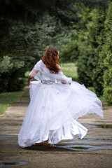 Fototapeta na wymiar bride in a white dress dances