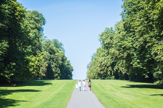 Family Walk together at Cirencester park in summer