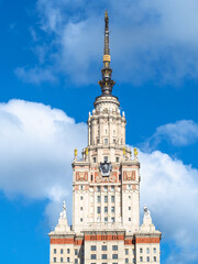 Fototapeta na wymiar top of The Main Building of Moscow State University (Lomonosov State University of Moscow) from east side in sunny summer day