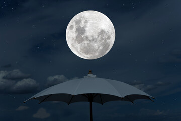 Full moon on the sky with umbrella at night.