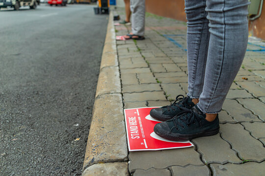 Social Distancing Sign For People Line Up In Front Of Grocery Store To Reduce Risk Of Crowded Gathering In Store During Covid-19 Or Coronavirus Crisis