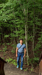 Naklejka na ściany i meble Man hiking in the forest in summer