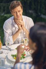 Portrait of blue eyed easygoing man resting with woman in the restaurant