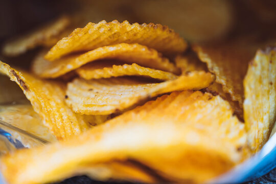 Close-up of crisps or chips falling out of the bag.