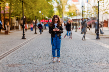 Fototapeta premium Portrait of a girl looking at her phone.