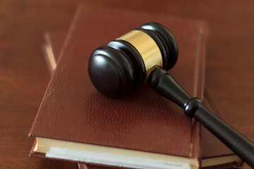 Judge's gavel lying on law books. Top view