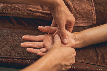 Woman receiving hand massage in wellness center