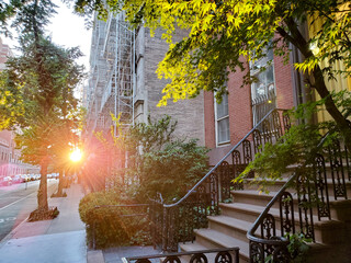 New York City - Sunlight shines on the buildings along a quiet street in the Greenwich Village...
