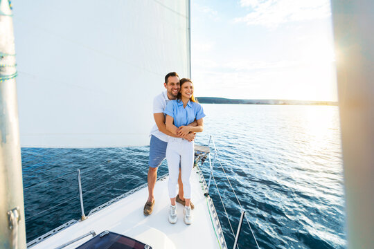 Couple Hugging On Yacht Spending Honeymoon Sailing Across The Sea