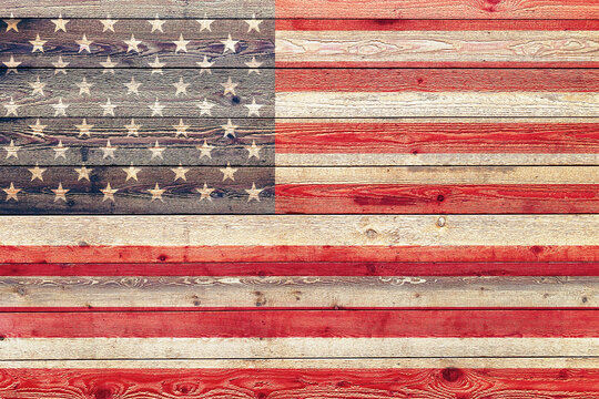 faded american flag painted on wood siding graphic with stylized stripes and stars