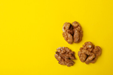 Tasty walnut on yellow background. Vitamin food