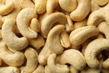 Tasty cashew nuts on whole background. Vitamin food