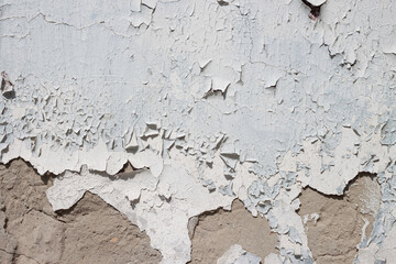 Grunge weathered shabby white peeled painted concrete surface wall with holes and cracks macro