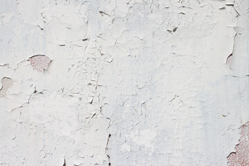 Grunge style urban weathered shabby white peeled painted concrete surface of the wall with holes, dirty and cracks macro