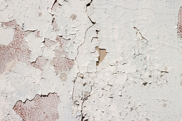 Shabby weathered peeled cement surface white painted wall texture pattern macro