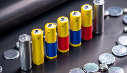 Batteries stand and scattered on the table. Concept of eco friendly behavior, recycling of harmful...