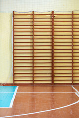 Gym for sports classes at school or College. Swedish wall, stairs, and wooden floor with markings for volleyball.