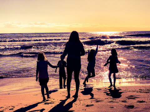 family walking on the beach