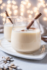 Traditional Christmas drink eggnog with cinnamon and Gingerbread man cookies